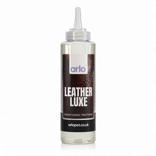 A clear plastic squeeze bottle of Arlo Leather Luxe Conditioning Treatment with a pointed applicator cap, shown on a white background.